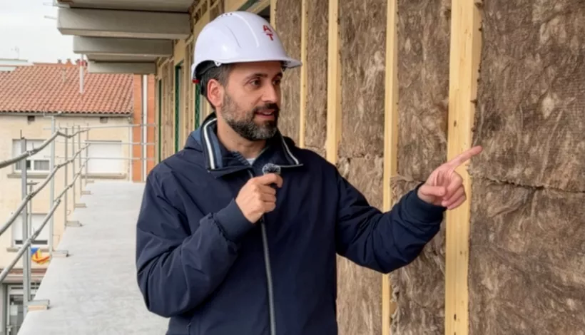 Jordi Martí, arquitecte tècnic i divulgador, assenyalant el sistema d'aïllament tèrmic d'una façana en rehabilitació
